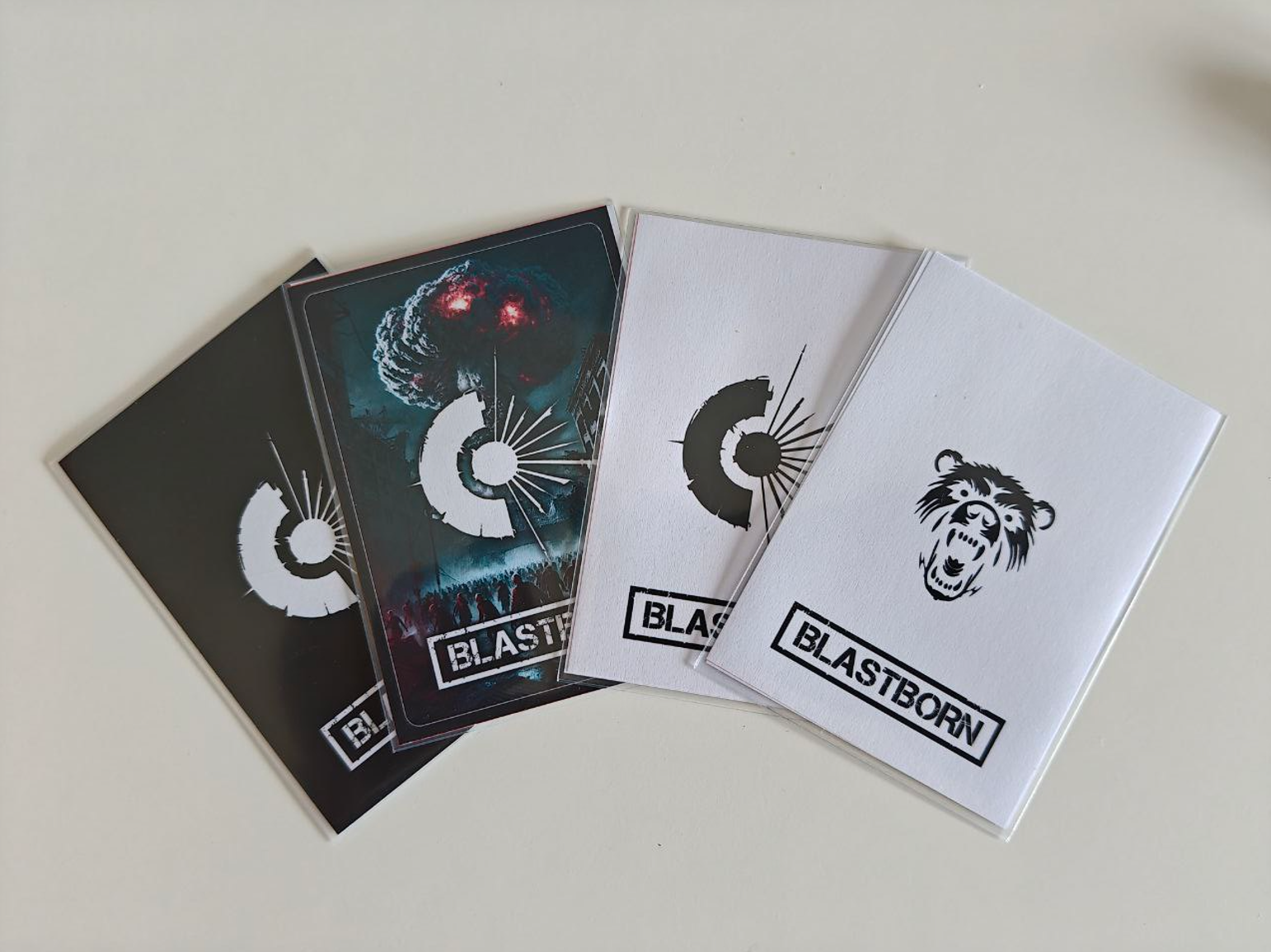 Front faces of the game cards, including white, black, coloured, and Gaia Wild faction designs Front faces of the game cards, including white, black, coloured, and Gaia Wild faction designs